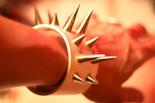 Load image into Gallery viewer, White leather cuff bracelet with brass spikes by Devilish Devices. Worn on wrist.
